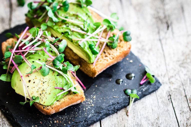 Delicious vegan sandwich with avocado and radish cress